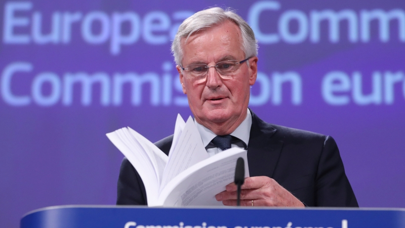 Michel Barnier holding a copy of the draft withdrawal agreement in Brussels