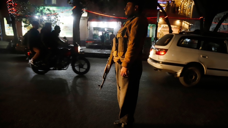 An Afghan soldier stands guard outside the hospital after a suicide attack targeted a religious gathering in Kabul