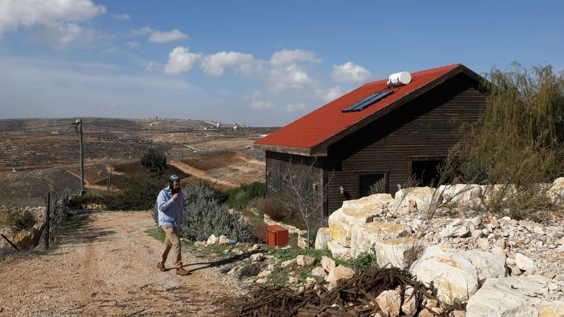 Nati Rom, who campaigns against the Palestinian-led boycott movement, walks next to an Airbnb apartment near a Jewish settlement