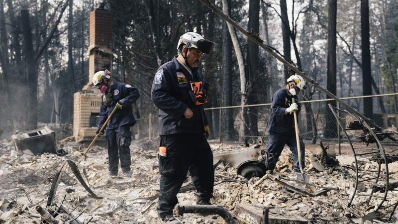 Search and rescue workers comb debris in Paradise, California