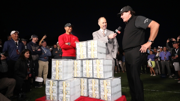 Phil Mickelson (R) beat Tiger Woods (L) to win $9m two years ago