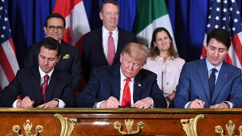 Mexico's President Enrique Pena Nieto, US President Donald Trump, and Canadian Prime Minister Justin Trudeau sign a new free trade agreement
