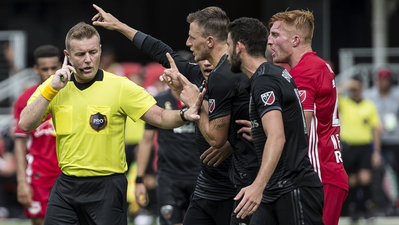 Alan Kelly (L) stays in control during the clash between DC United and the New York Red Bulls