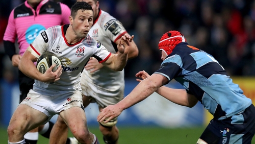 John Cooney (L) is tackled by and Seb Davies of Cardiff