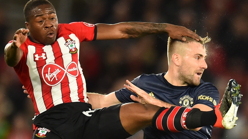 Michael Obafemi (L) competes with Luke Shaw