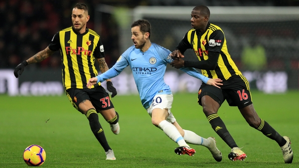 Bernardo Silva of Manchester City takes on Abdoulaye Doucoure (16) and Roberto Pereyra of Watford (37)
