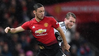 Nemanja Matic of Manchester United is challenged by Andre Schurrle of Fulham