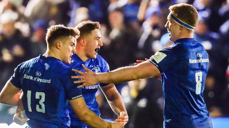 Jordan Larmour celebrates his try with Garry Ringrose and Dan Levay