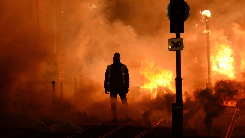 A protester stands near a fire in Bordeaux, southwestern France | Image: Nicolas Tucat/AFP/Getty