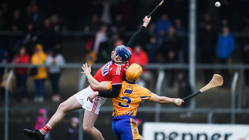 Cork's Jamie Coughlan and Jason McCarthy of Clare battle for possession