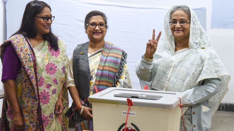 Bangladeshi Prime Minister Sheikh Hasina (R) castS her vote, as her daughter Saima Wazed Hossain (1st L) and her sister Sheikh Rehana (2nd L) look on
