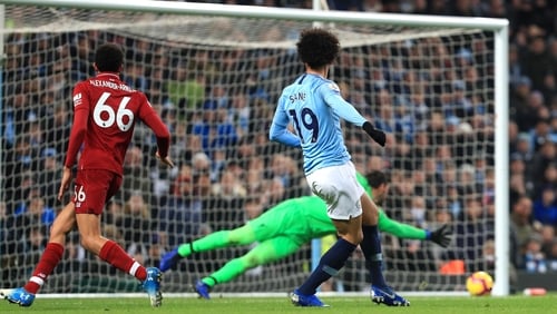 Leroy Sane shoots to score past Liverpool goalkeeper Allison