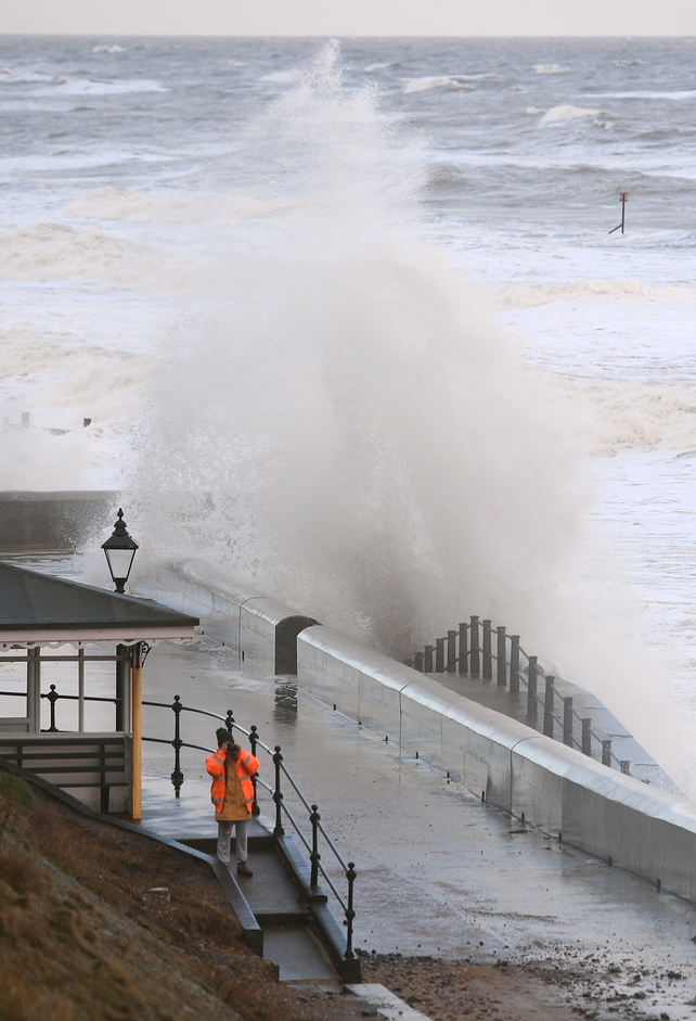 Waves crash against the sea wall at Cromer in Norfolk