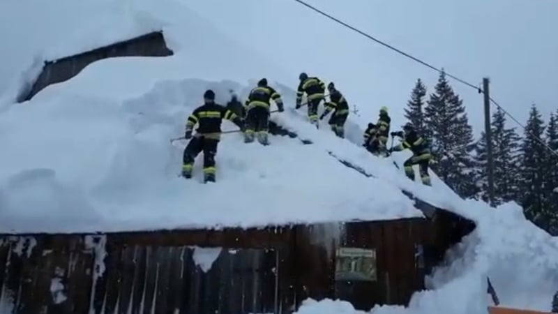 Volunteer firefighters in the ski resort of Hohentauern work to clear snow