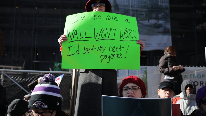 Hundreds of federal workers and contractors rally against the partial federal government shutdown in Washington, DC