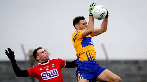 Dean Ryan collects the ball ahead of Cian Kiely
