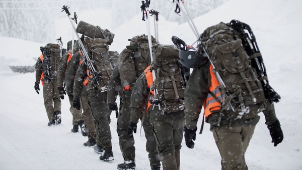 Austrian soldiers walk at the valley station of the Hochkar cable car in Austria