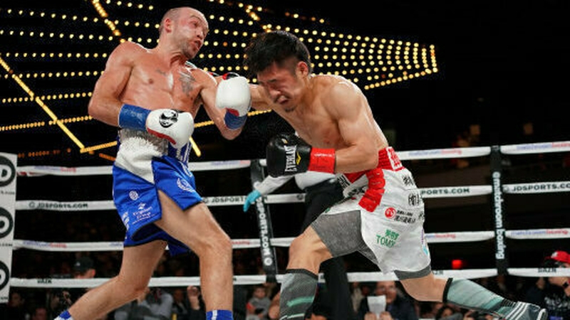 TJ Doheny, in blue shorts, dodges a punch from Japan's Ryohei Takahashi at Madison Square Garden