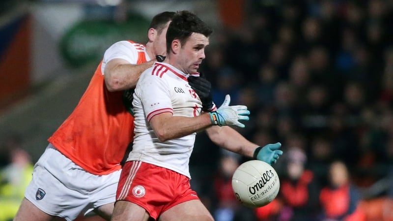 Tyrone's Darren McCurry holds off Brendan Donaghy of Armagh at the Athletic Grounds