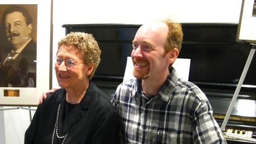 Alyce Mott and Guy Livingston seated at Victor Herbert's piano in the offices of ASCAP in New York.