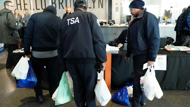 An employee of the Transportation Security Administration at the food bank in NYC