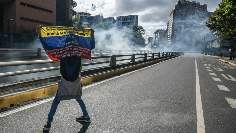 A demonstrator holding the Venezuelan flag during an opposition rally in the capital Caracas