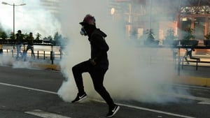 <p>The security forces respond with tear gas</p>