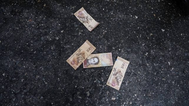 <p>People threw Venezuela banknotes on the floor as a sign of protest</p>