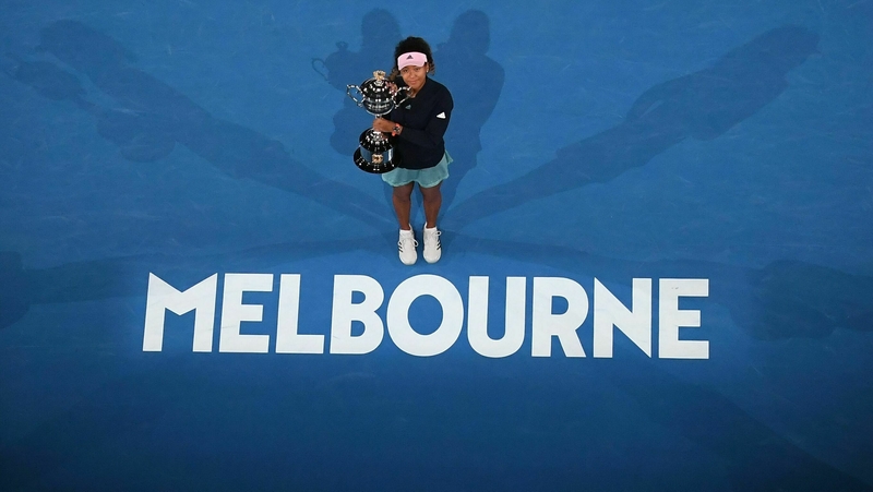 Centre stage: Japan's Naomi Osaka celebrates with the trophy