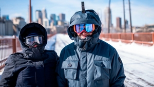 Jen and Aaron Brackman wrap up well as they cross the Stone Arch Bridge in Minneapolis