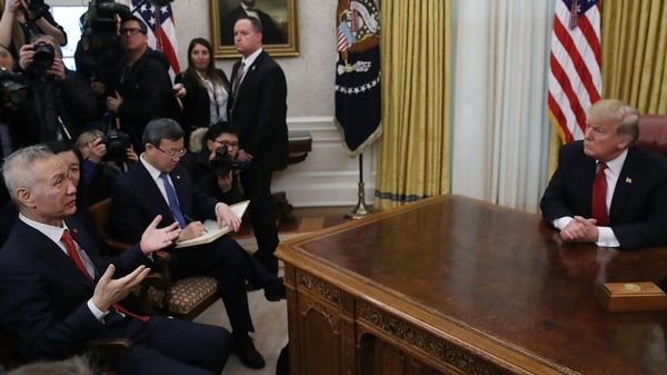 Chinese trade envoy Liu He (L) addresses President Trump at the White House
