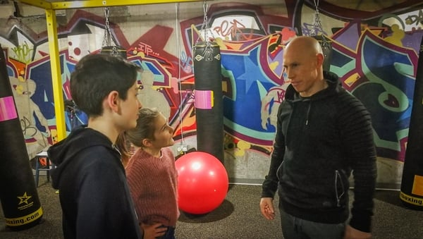 Young presenters Darcy and Darragh corner Peter Stringer in the gym