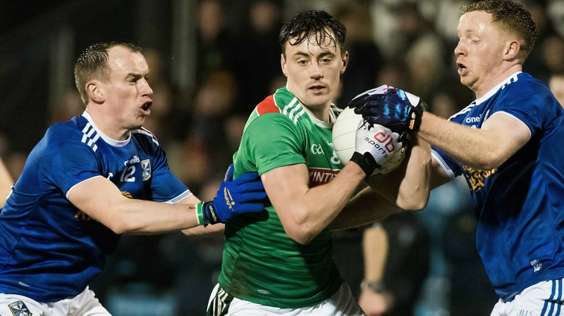 Diarmuid O'Connor is tackled by Martin Reilly and Jack Brady
