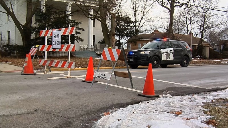 Police officers guarding the area where a gunman opened fire in an industrial area of Aurora, Illinois