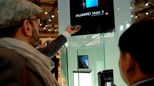 Visitors interact with a Huawei Mate X presentation at the Mobile World Congress