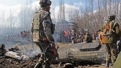 Indian army and locals stand near the wreckage of the military aircraft that crashed down today