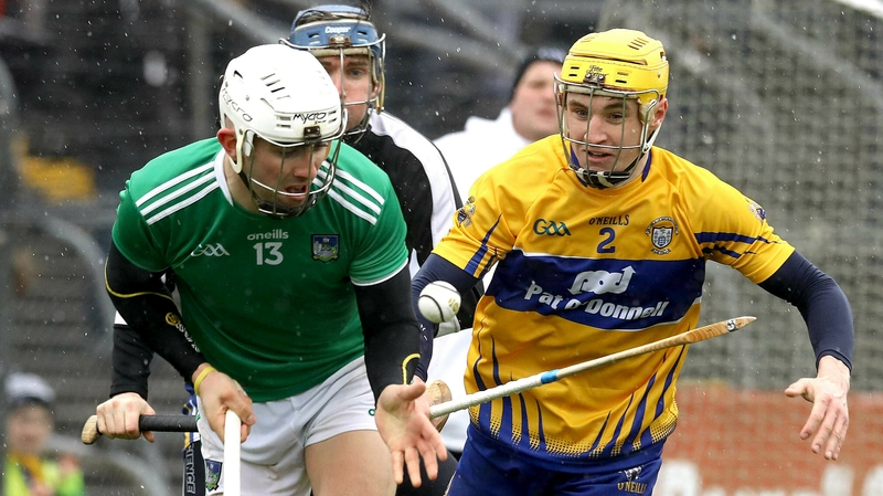 Aaron Gillane pops a pass away as Rory Hayes and Donal Touhy hover behind him