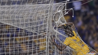 Julián Quiñones of Tigres gets caught in the net during his side's game with Pachuca in Mexico