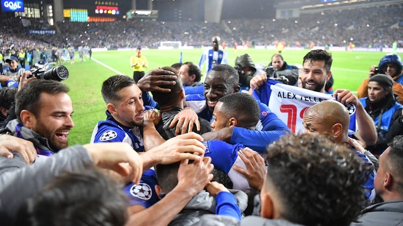 Porto players celebrate their late winner as they beat Roma 4-3 on aggregate to reach the Champions League quarter-finals