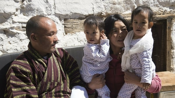 The twins are seen with the parents after their arrival in Bhutan