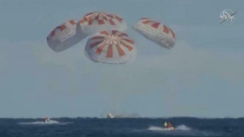 Live footage from NASA showed the capsule splashing down into the ocean