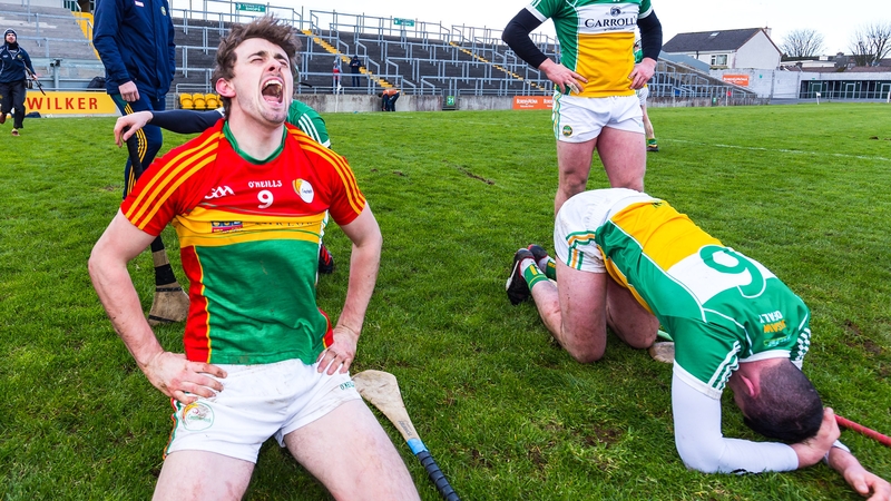 Sean Whelan celebrates alongside a dejected Pat Camon and Sean Dolan