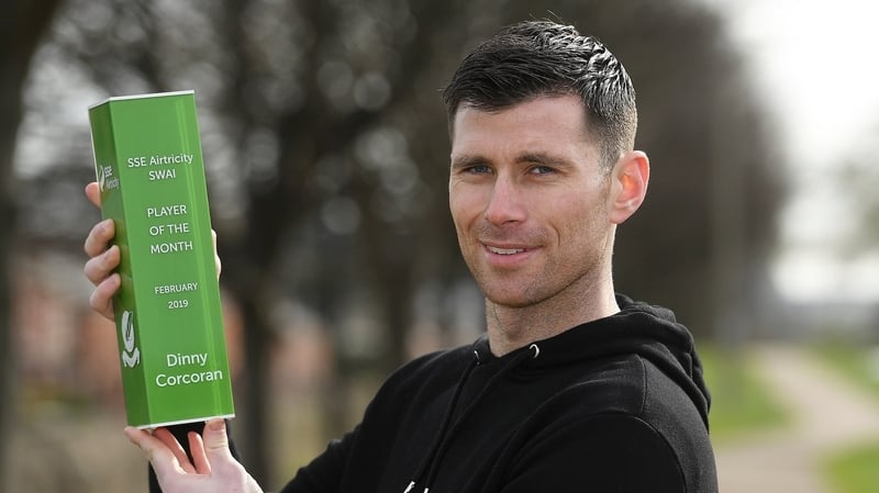 Corcoran posing with his award