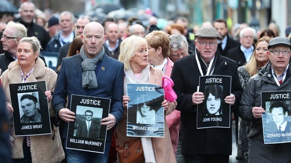 Families of some of the victims are seen during a march in Derry this morning