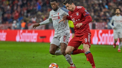 Georginio Wijnaldum (L) battles Robert Lewandowski of Bayern Munich