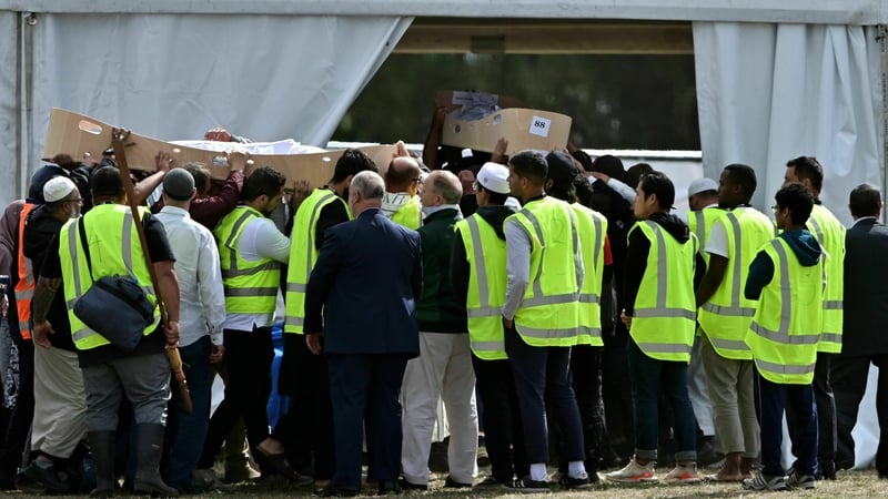 Mourners carry the coffins of Khalid Mustafa and his son Hamza Mustafa