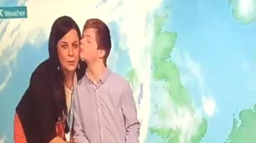 Cameron McNamara plants a kiss on the unsuspecting Audrey McGrath on the RTÉ Weather set