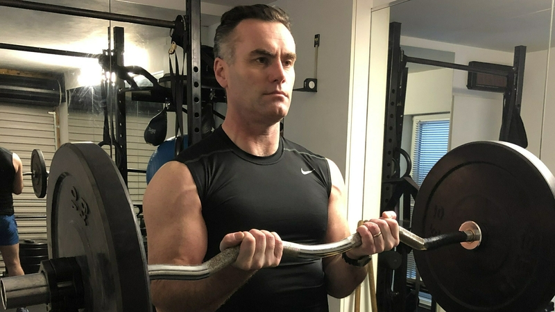 EZ bar closed grip bicep curl - finish position.