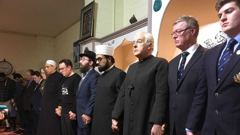 Faith leaders at the special gathering join hands for a minute of silent prayer in the Blanchardstown Mosque