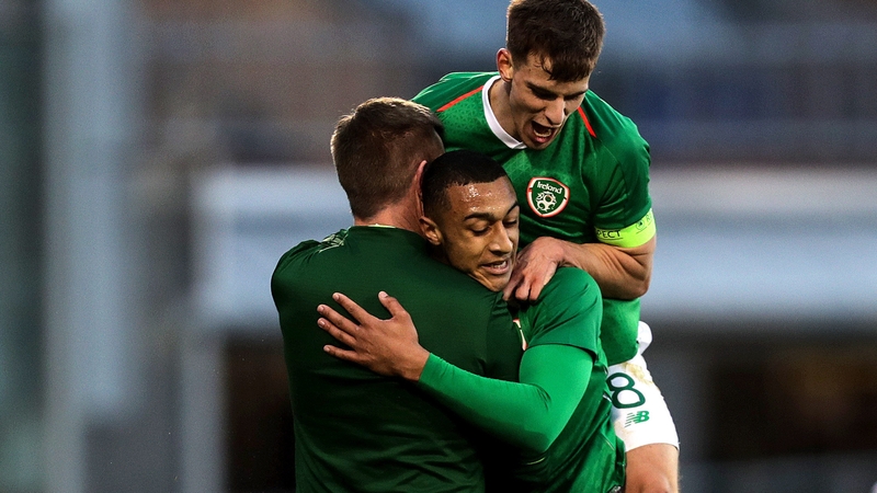 Adam Idah celebrates scoring a goal with Ireland manager Stephen Kenny and Jayson Molumby
